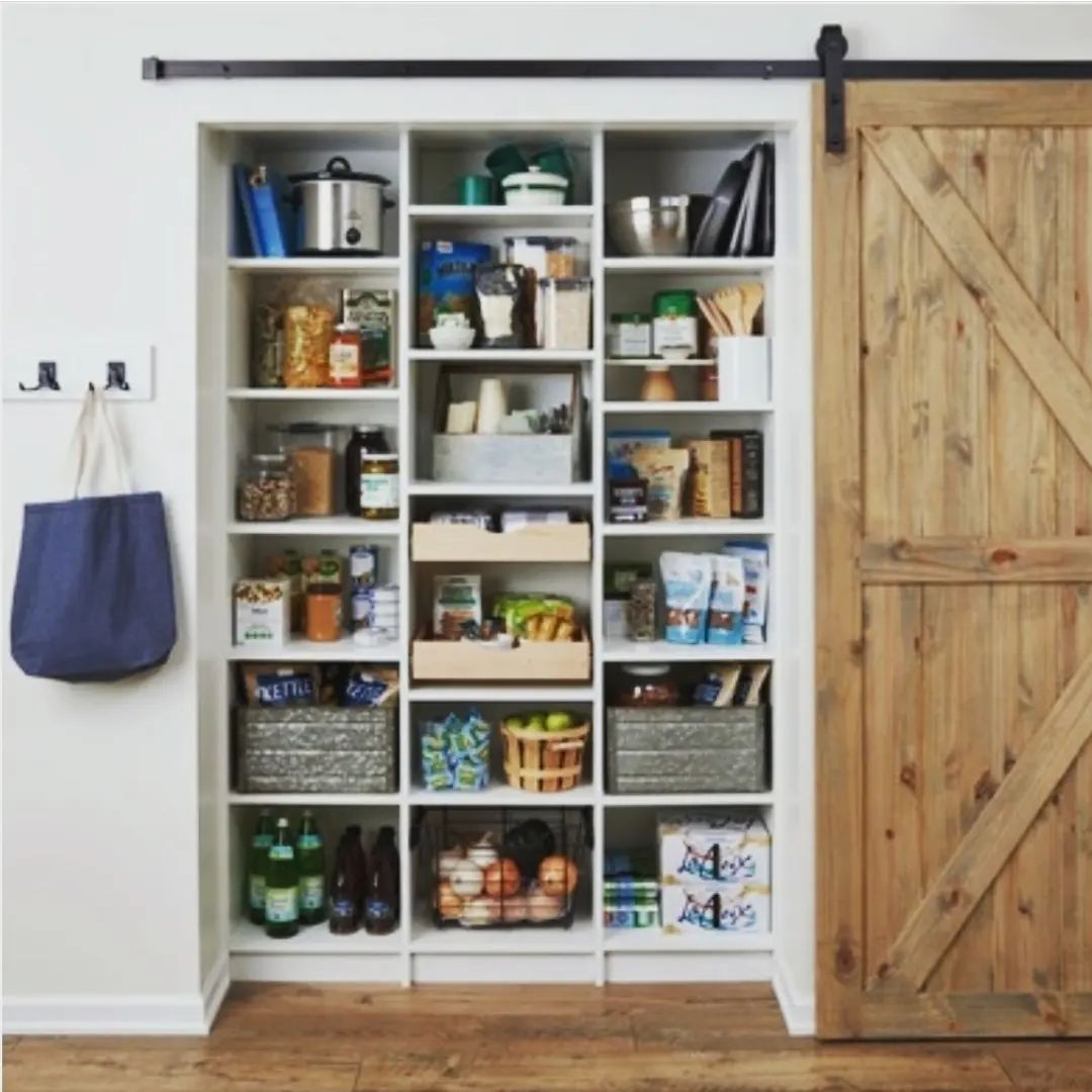 Custom pantry with barn door and organized shelving in Auburn Alabama