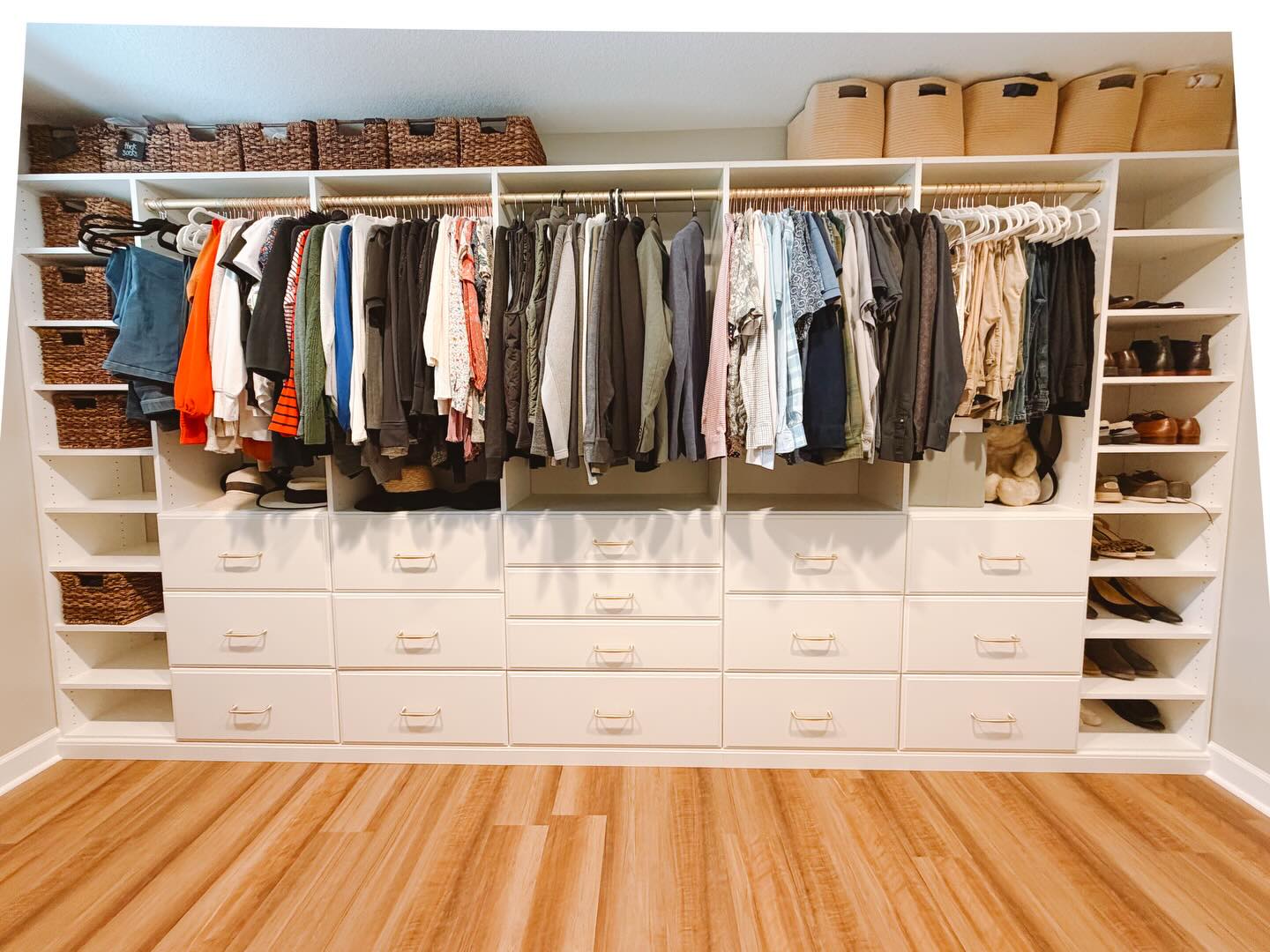 Custom walk-in closet with shelving and drawers installed in Auburn Alabama